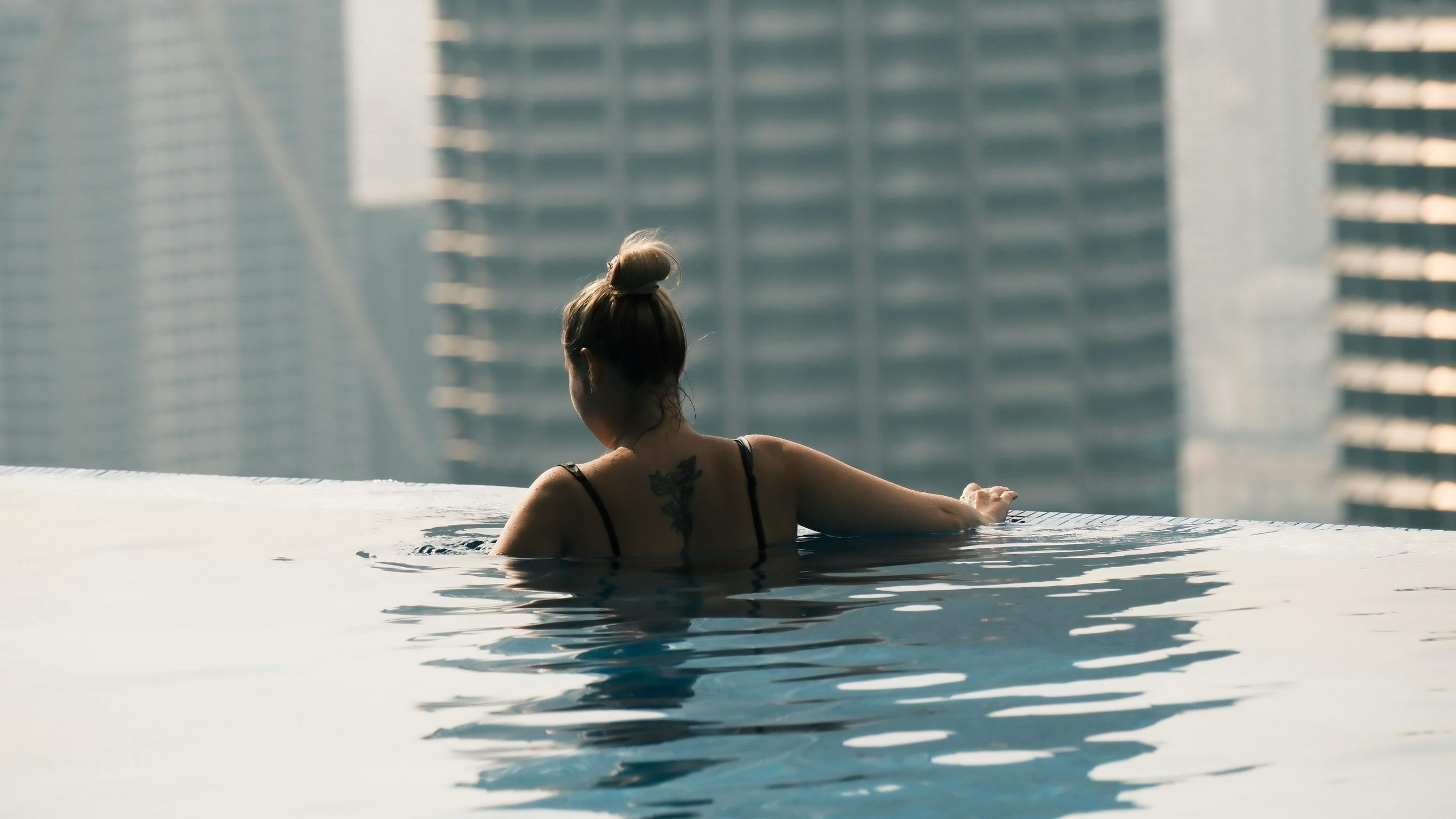 A Lady Enjoying In Rooftop Pool