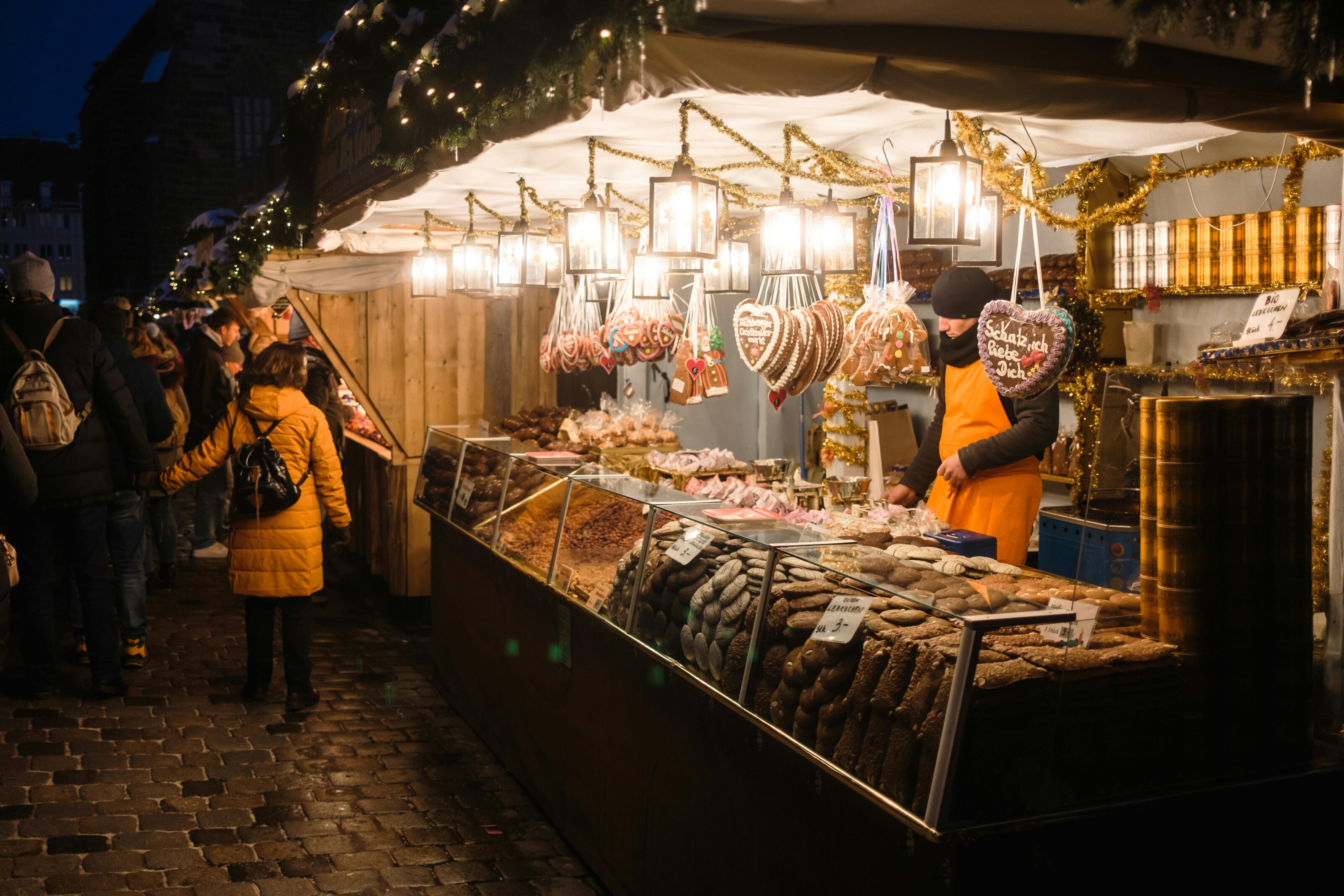 People Enjoying Gingerbread In Nuremberg, A City With The Best Christmas Markets In Europe