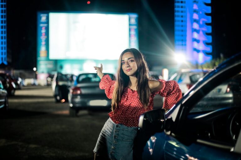 A Young Woman Pointing Towards A Screen Of A Drive-In Theatre In Chicago