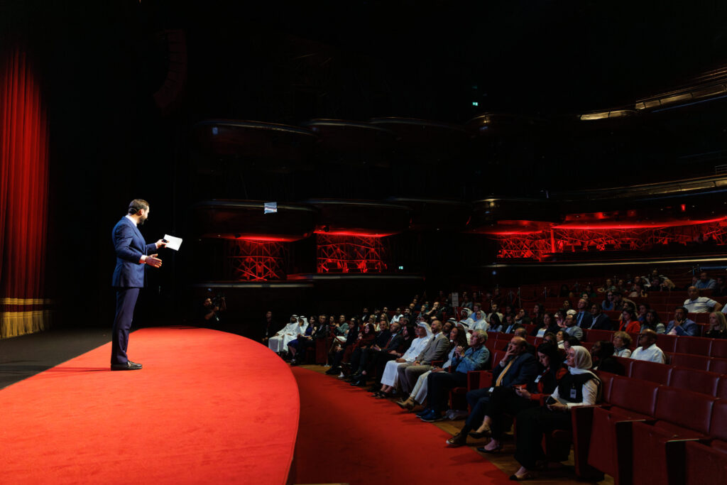 Speaker Addressing Audience At Dubai Opera Auditorium